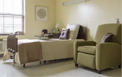 Private room with bed and lounge chair